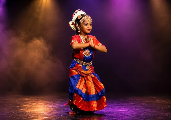 Young Bharatanatyam student in Namaskaram posture on stage at Spotlight Academy, Spring & The Woodlands TX