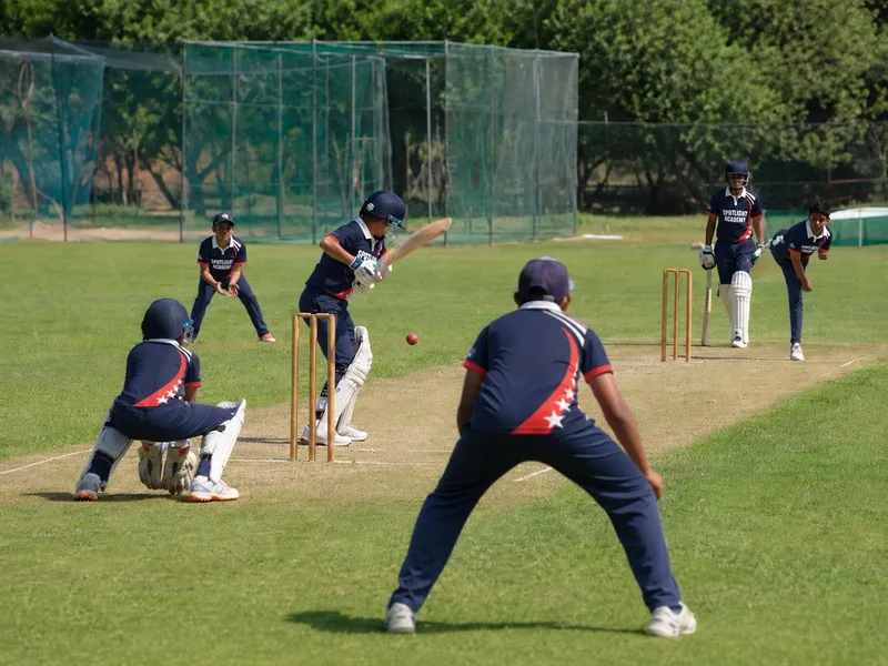 Spotlight Academy cricket students playing a match with batter, wicket keeper and fielders, The Woodlands TX